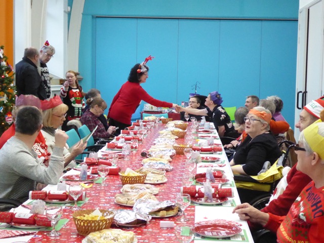 Members and volunteers at the Christmas party enjoying the party.